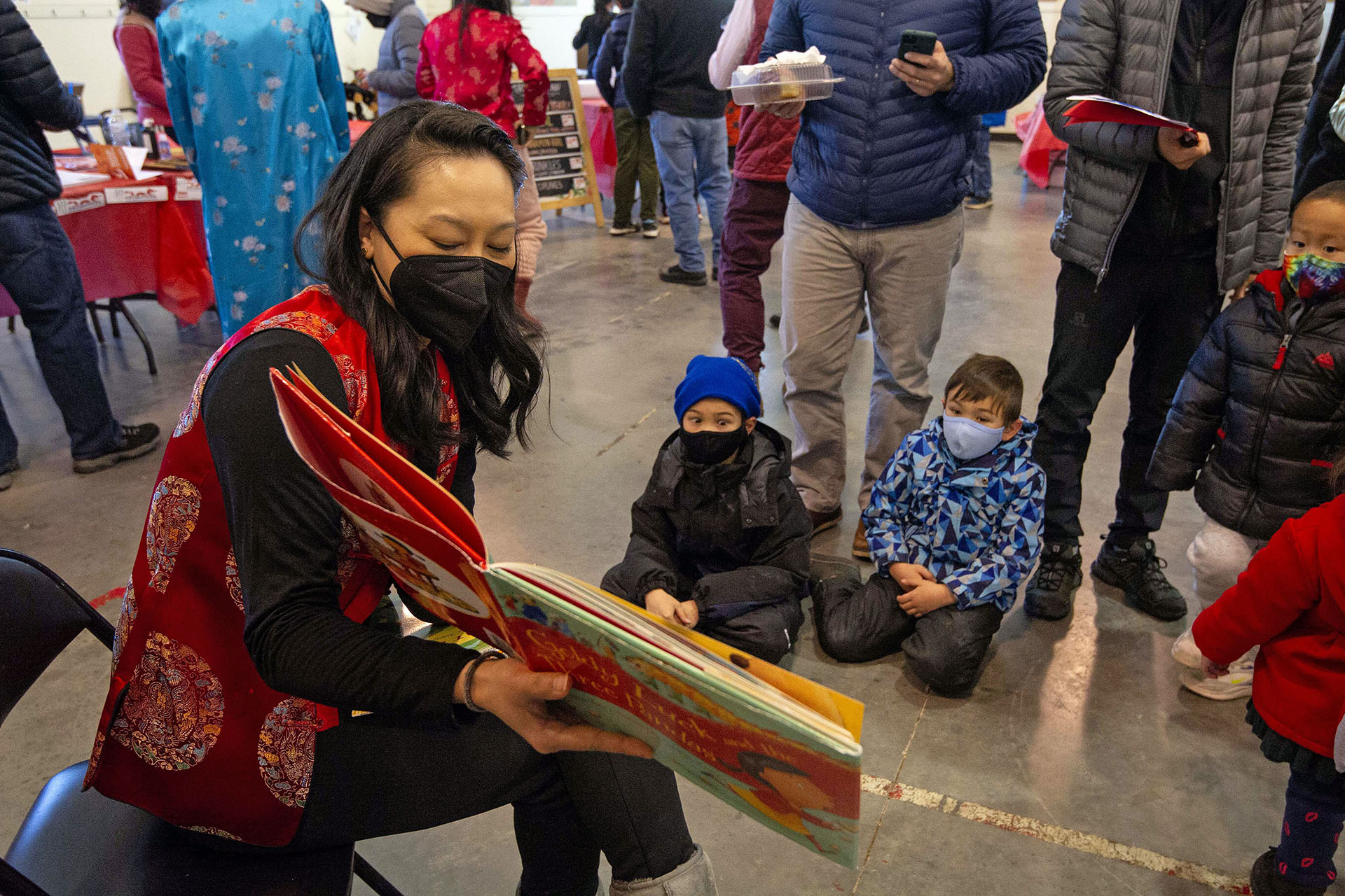 Regina Shih reads a story to children during the Lunar New Year Celebration at Legacy Park in Decatur on Saturday, Jan. 29. 2022. Photo by Dean Hesse.