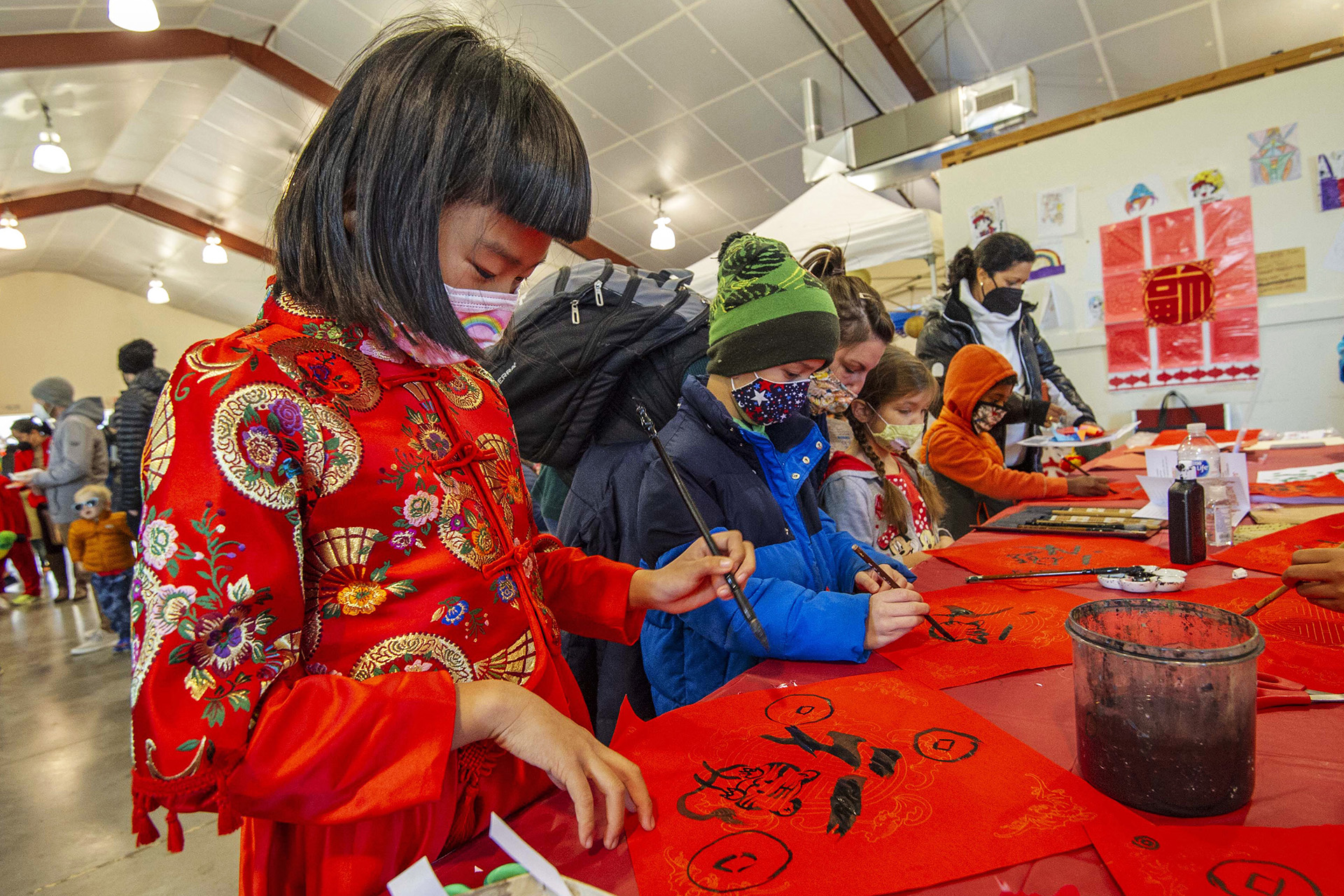 Nine-year-old Crystal Liang paints at the Atlanta Contemporary Chinese Academy table during the Lunar New Year Celebration at Legacy Park in Decatur on Saturday, Jan. 29. 2022. Photo by Dean Hesse.