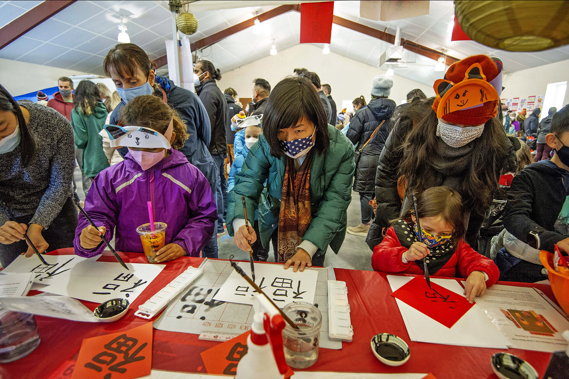 People paint at the China passport station during the Lunar New Year Celebration at Legacy Park in Decatur on Saturday, Jan. 29. 2022. Photo by Dean Hesse.