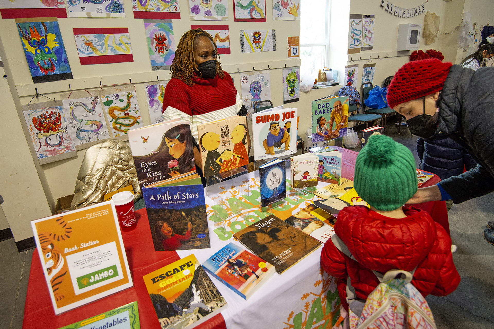 Jambo Books owner Mijha Godfrey with her display of books starring children of color at the Lunar New Year Celebration at Legacy Park in Decatur on Saturday, Jan. 29. 2022. Photo by Dean Hesse.